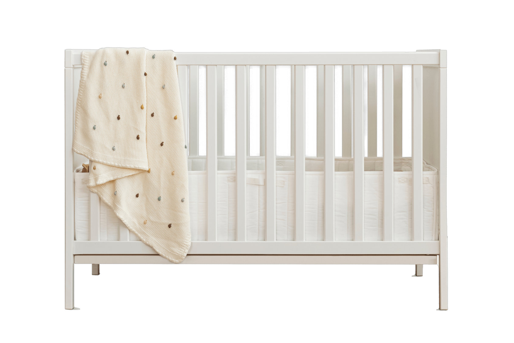 Beutiful White Cot with white with dot colour blanket on the left side as decoration